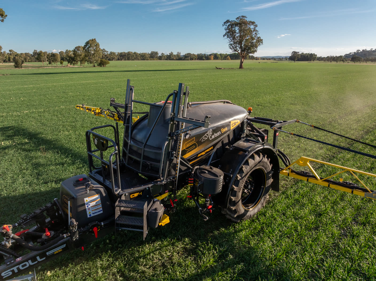 Aerial view of a Stoll CB4 in a green paddock with its boom out