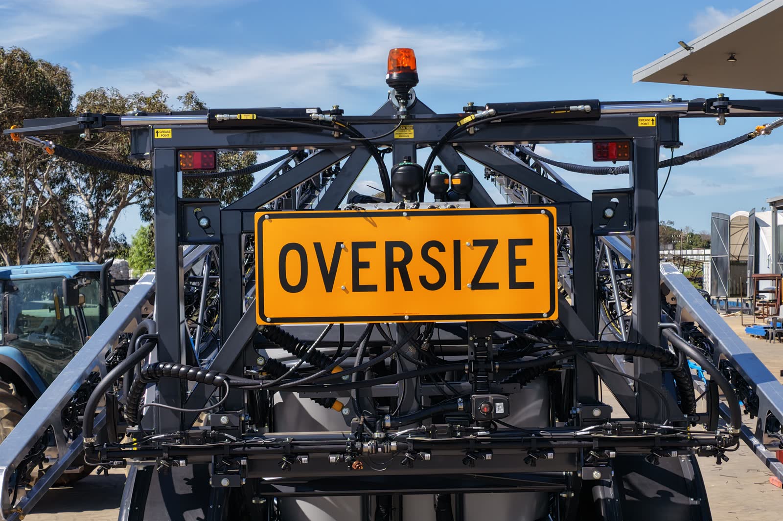 The rear of a Stoll CR5 with its boom folded and an oversize sign