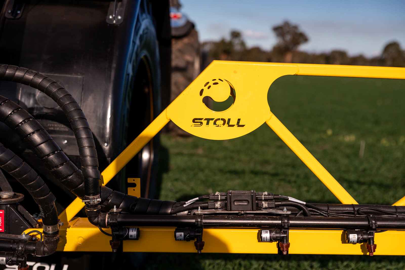 Yellow boom frame with the Stoll logo cut into the steel