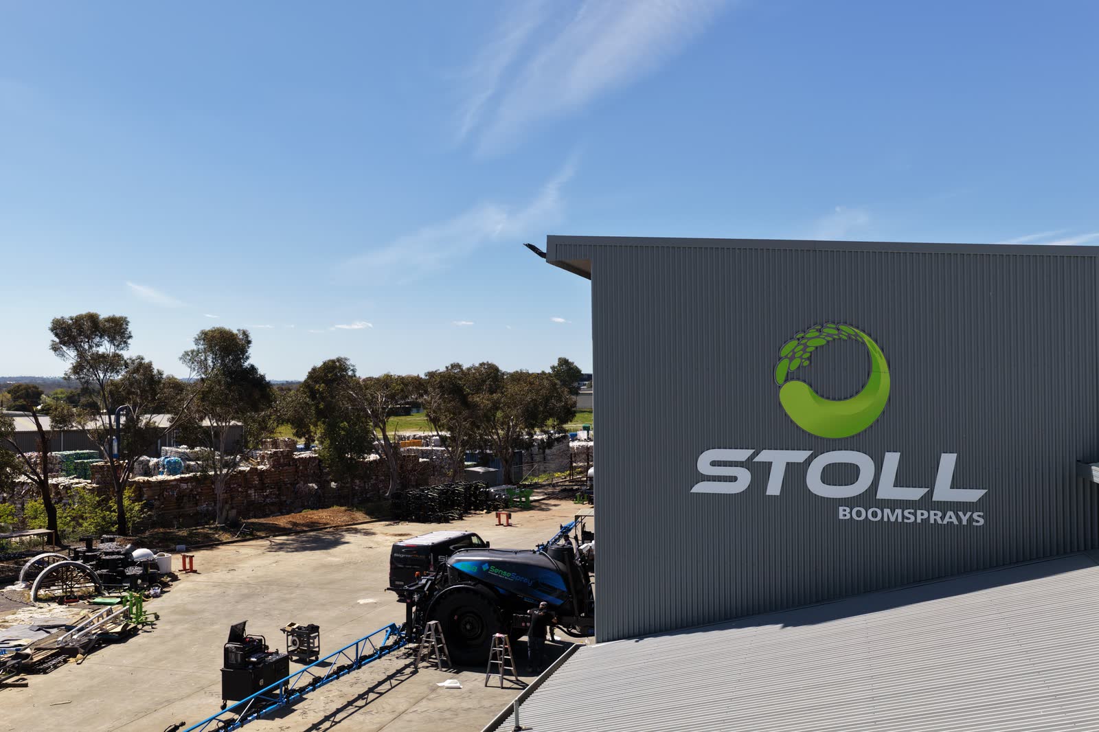 The Stoll Boomsprays factory at Wagga Wagga, with a sprayer being worked on in the yard