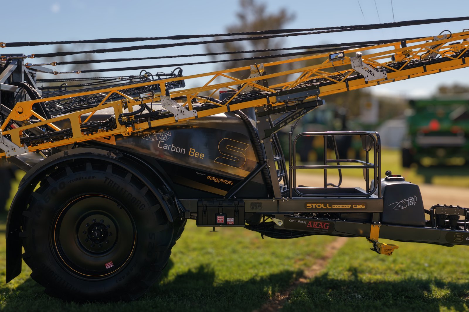 A Stoll CB6 side on with its yellow boom folded, on the stand at the Henty Machinery Field Days
