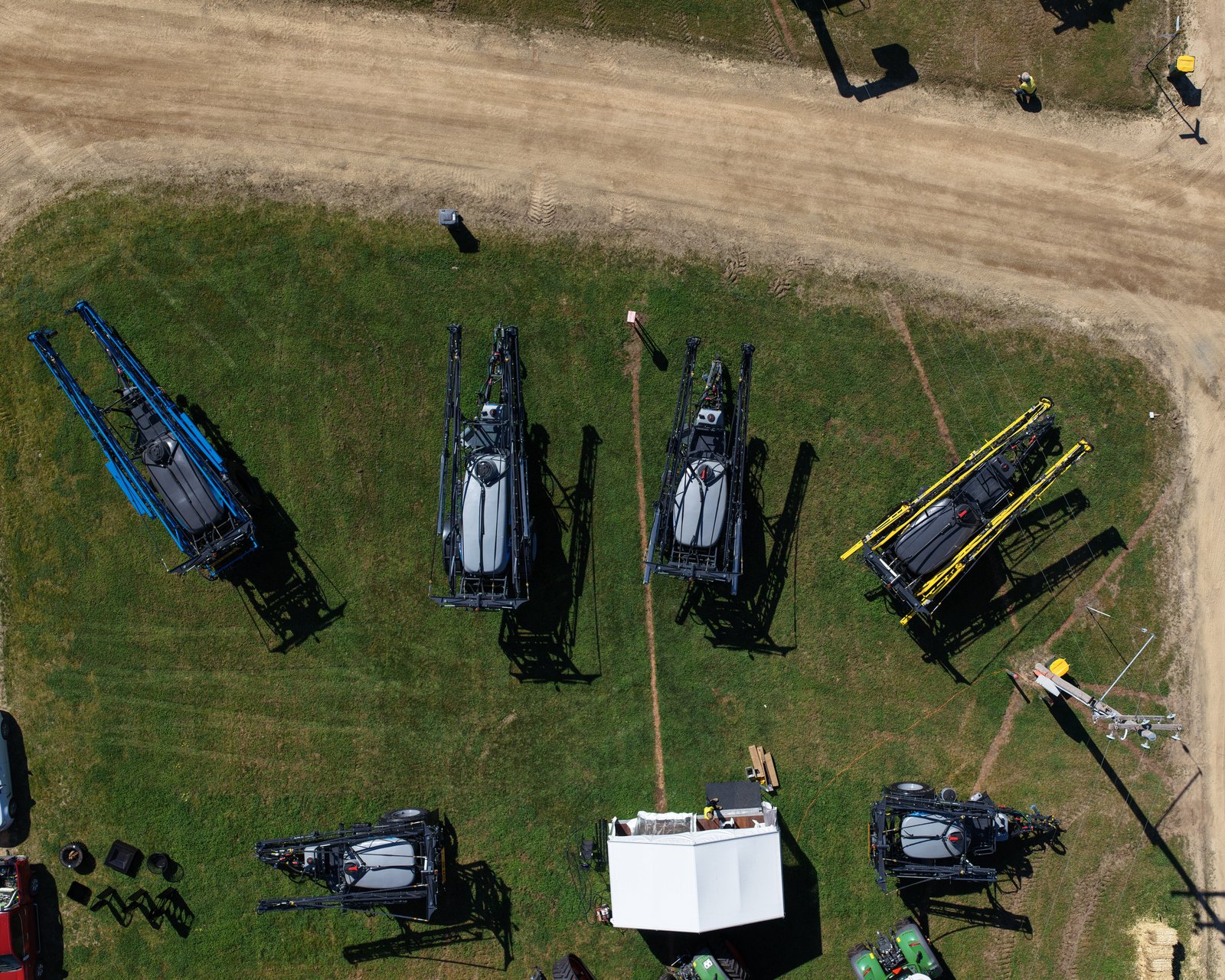 The Stoll’s stand at Henty from directly above: six sprayers laid out on the grass beside the track