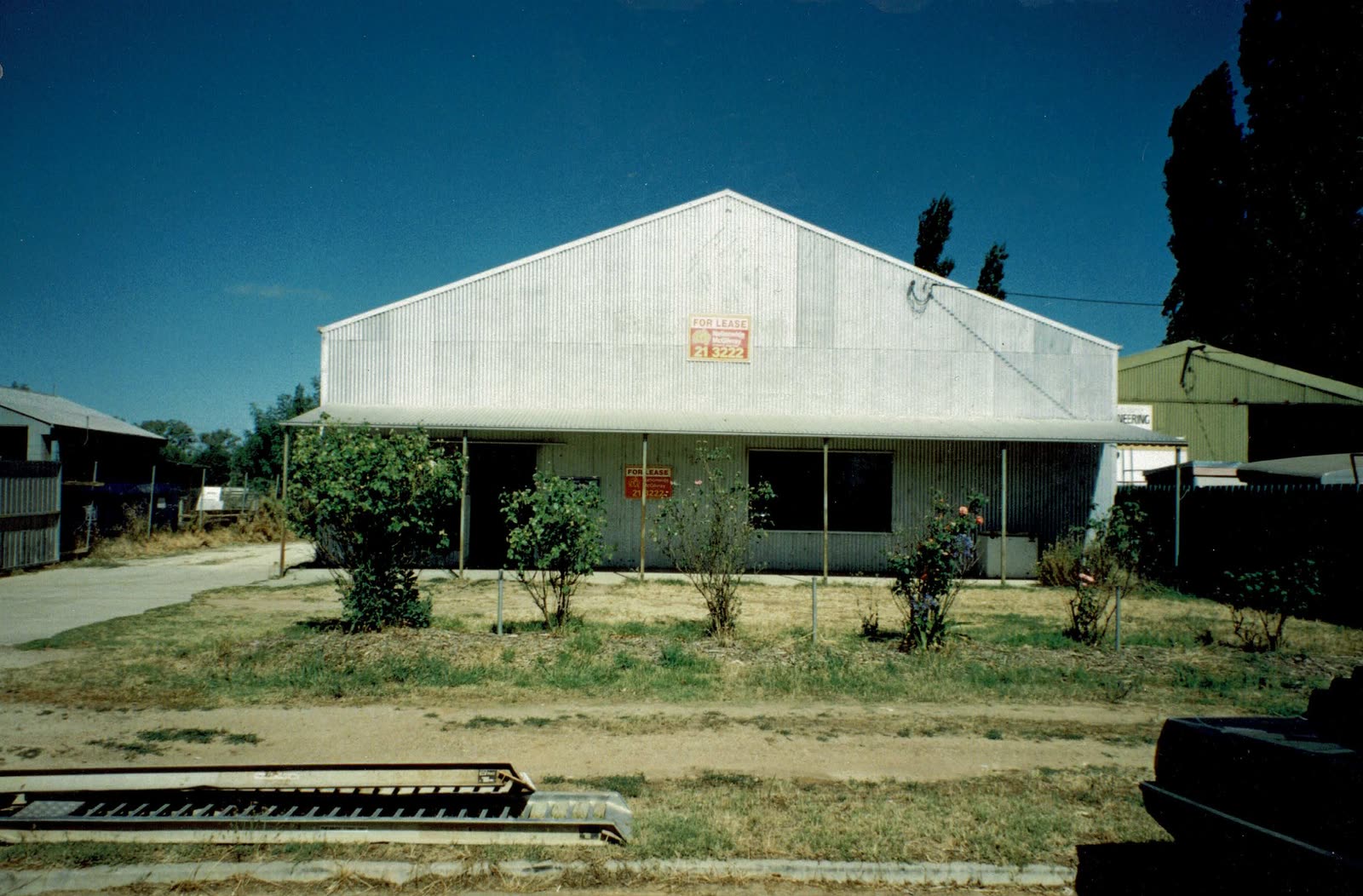 A corrugated iron shed in Wagga Wagga with a for lease sign on the gable