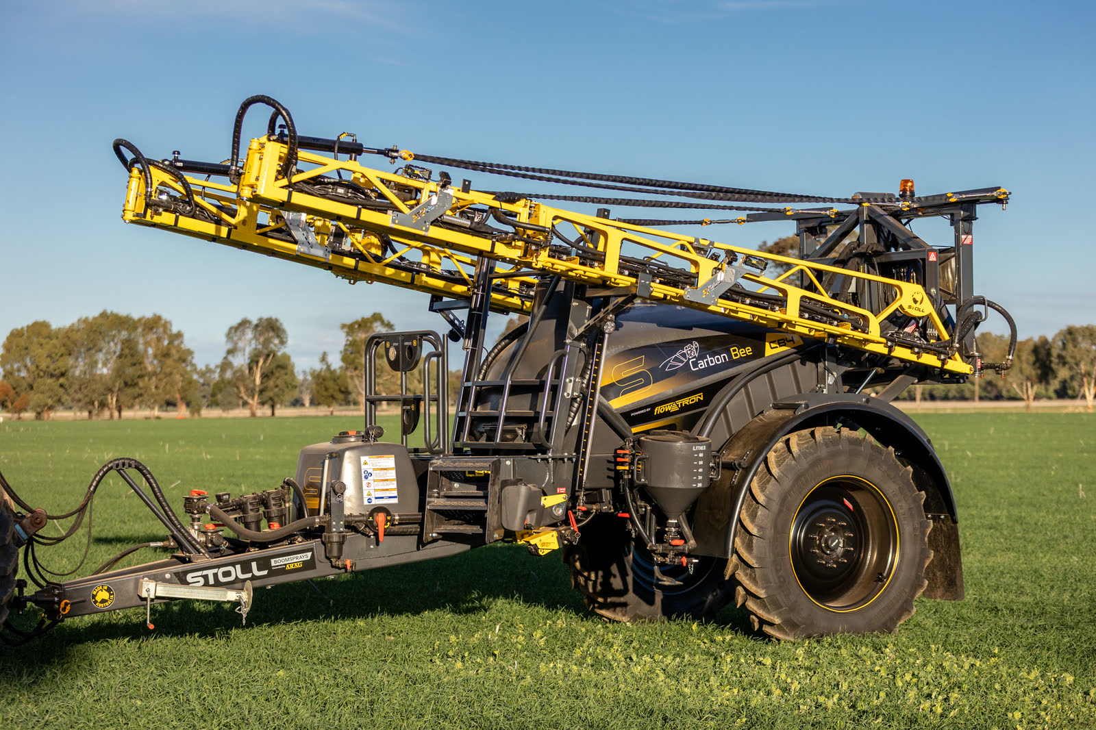 Stoll CB4 trailed boomspray with its boom folding, side on in a paddock
