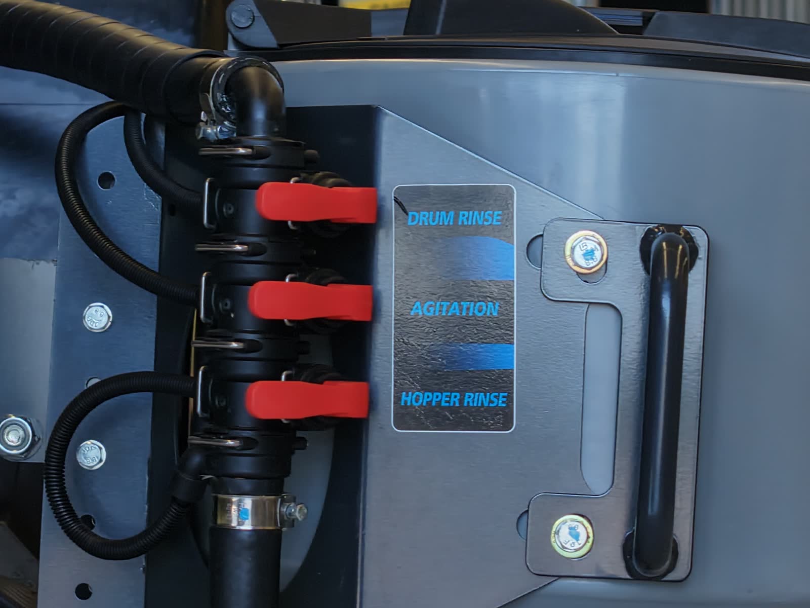 Valves labelled drum rinse, agitation and hopper rinse on a Stoll S3