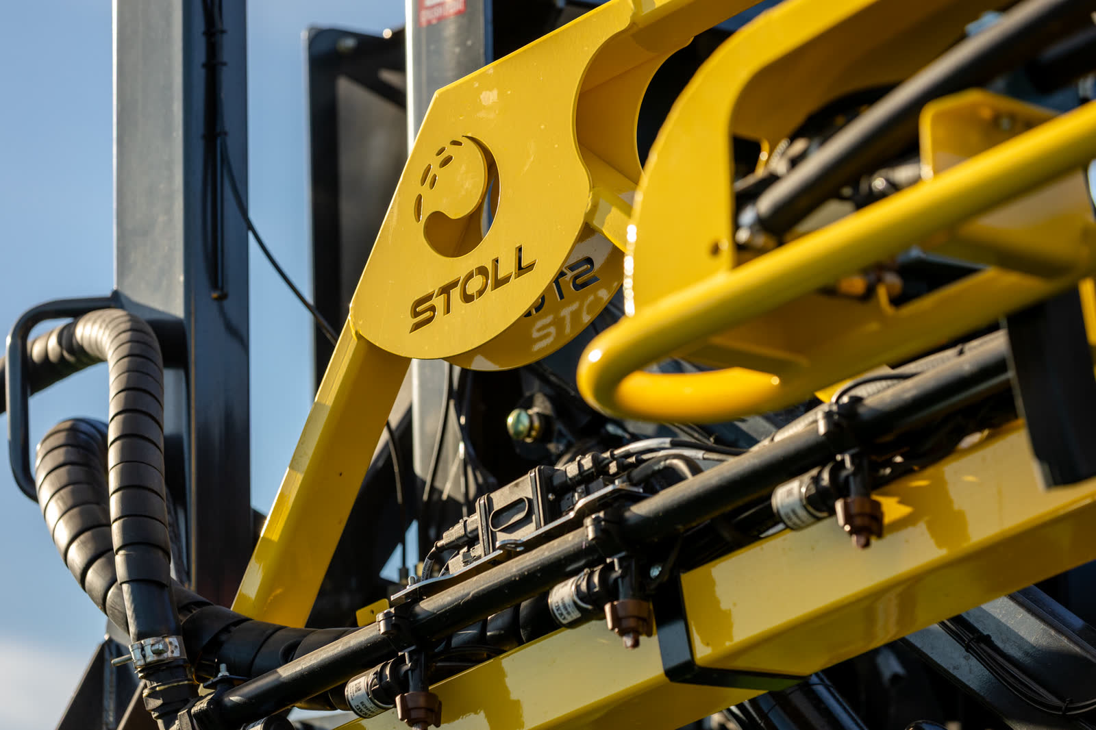 The Stoll logo cut into a yellow boom frame